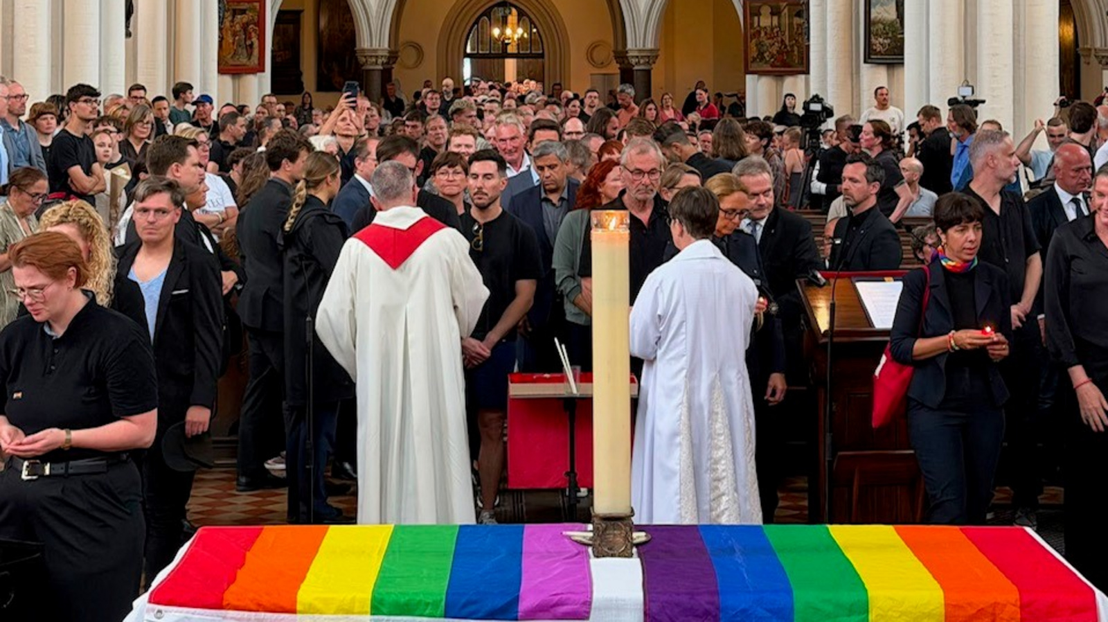 Zu sehen ist die Andacht am Sonntagnachmittag, in der viele Menschen der Opfer des mutmaßlich islamistischen Anschlags im Umfeld des CSD vom Samstagabend gedachten.